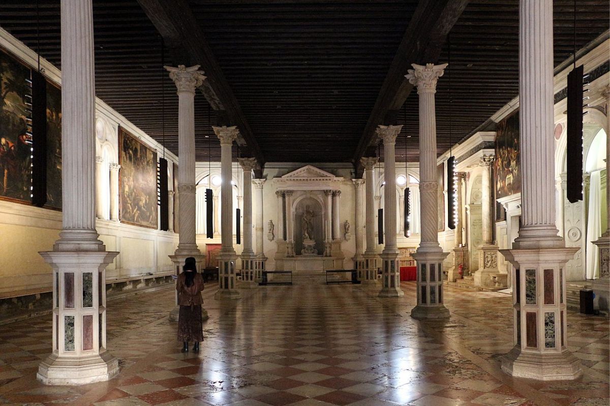 Den nedre salen i Scuola Grande di San Rocco i Venezia, med sjakkrutete gulv, søyler og store teleri-malerier av Tintoretto.