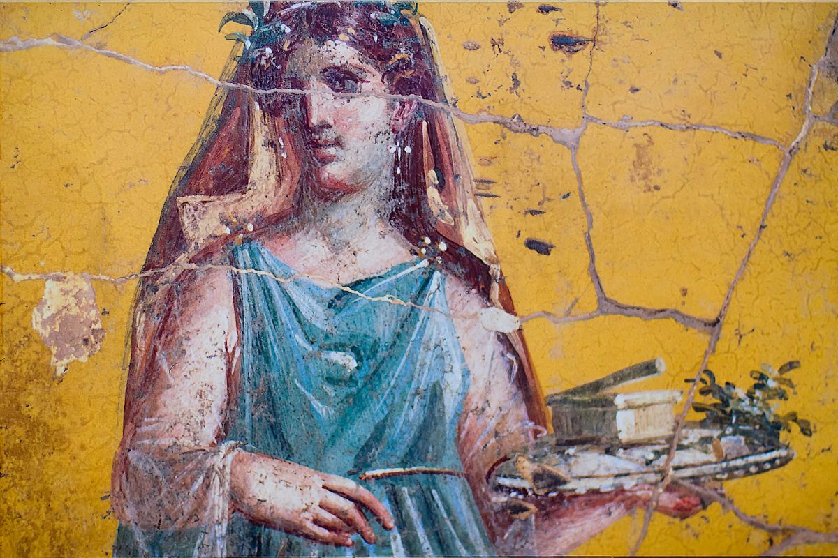 Antikt veggmaleri fra Pompeii som viser en kvinne med krans og gjenstander på et brett – et typisk eksempel på romersk freskokunst.
